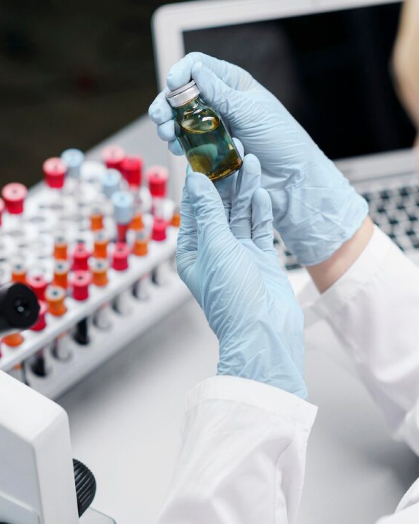 female-researcher-laboratory-with-test-tubes-vaccine-bottle_23-2148816401